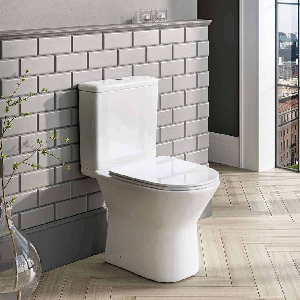 Sleek white ceramic toilet in modern bathroom with grey subway tile wall, natural light, and city view, showcasing premium bubly bathroom fixtures and contemporary design.
