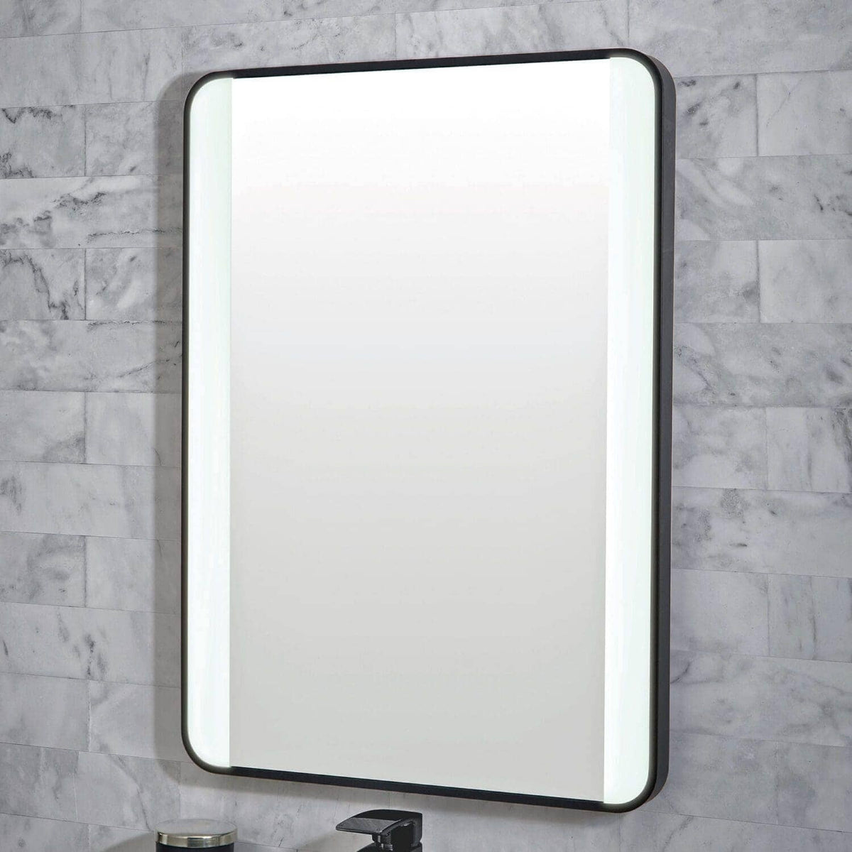 Illuminated modern bathroom mirror with LED lighting, sleek black frame, mounted on grey marble wall, ideal for contemporary bathroom decor and grooming needs.