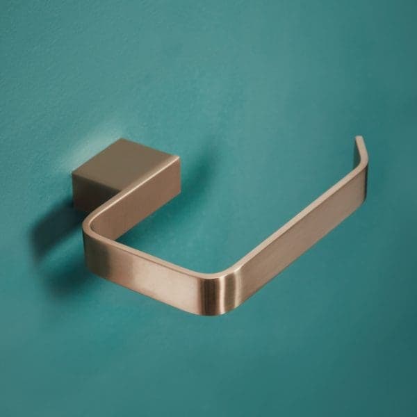 Brushed stainless steel toilet paper holder mounted on turquoise bathroom wall.