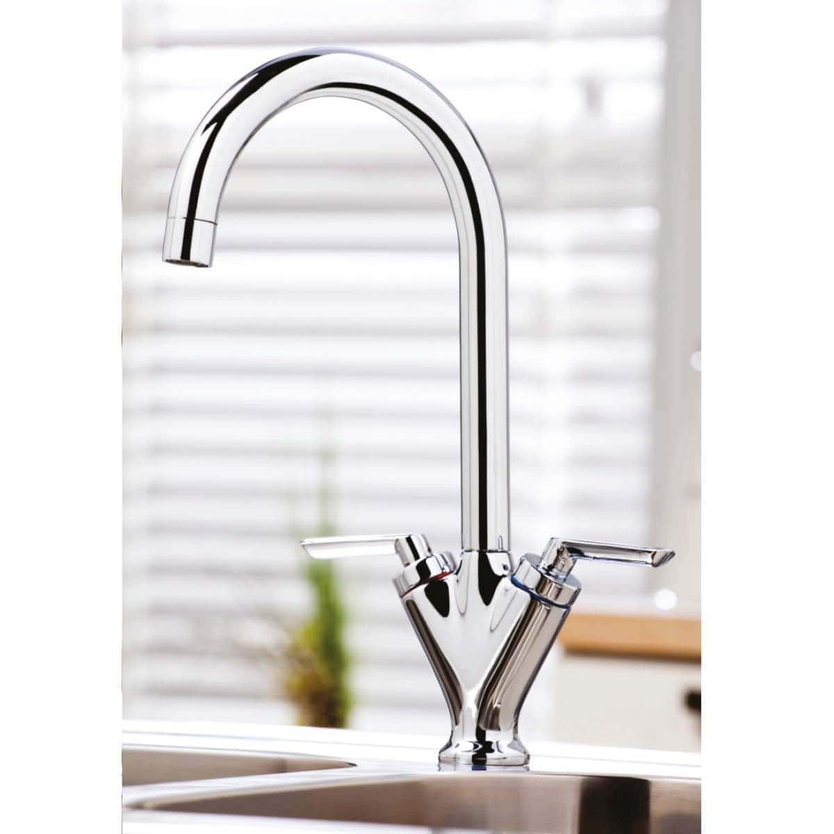 Sleek chrome kitchen tap with high arch and dual lever control, ideal for modern kitchens, providing efficient water flow and easy operation.