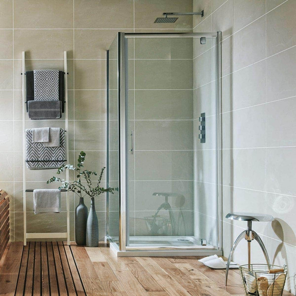 Modern glass shower enclosure in contemporary bathroom with beige tiled walls and wooden floor, complemented by sleek accessories and towel racks.