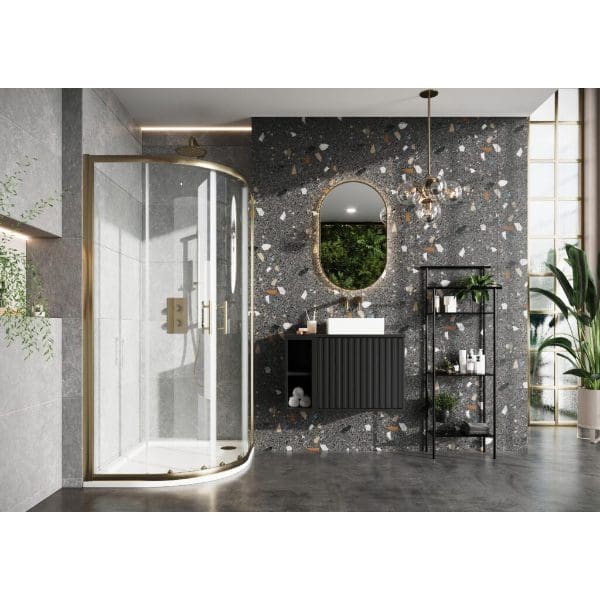Contemporary bathroom with a glass shower enclosure, textured terrazzo wall, black vanity unit, and a stylish mirror, featuring modern lighting and greenery for a chic, functional space.