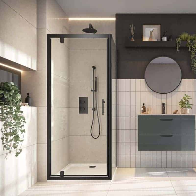 Modern walk-in shower with black frame, beige wall tiles, and minimalistic fixtures in a contemporary bathroom.