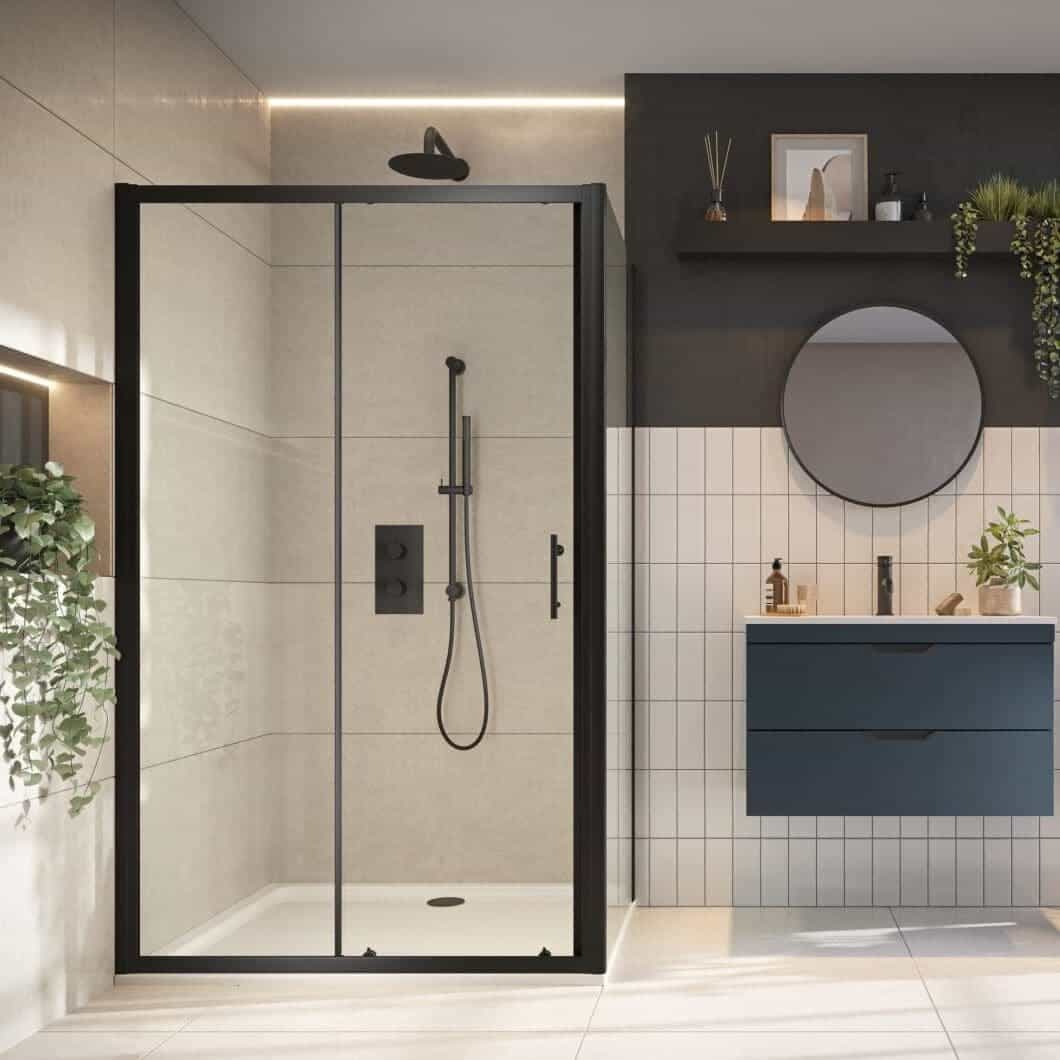 Modern walk-in shower with black framing, beige tiles, and rainfall showerhead in contemporary bathroom. Stylish minimalist design with dark and light contrasting tiles, greenery, and sleek vanity.
