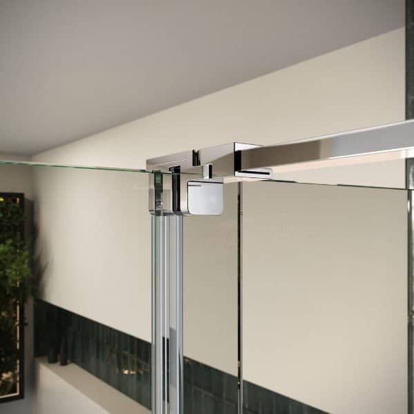 Glass shower partition with metal hinges and support bar in modern bathroom design.