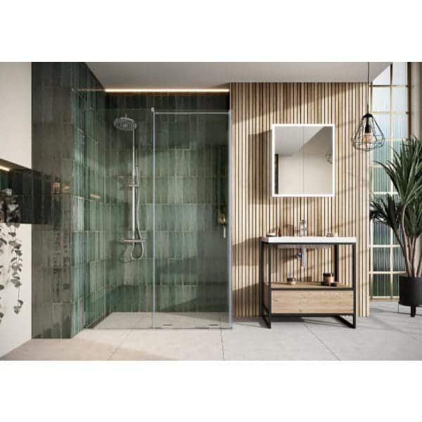 Modern bathroom with walk-in shower and wooden vanity, featuring sleek glass enclosure, green tiled wall, and natural lighting from large window, showcasing contemporary Bubly Bathrooms design elements.