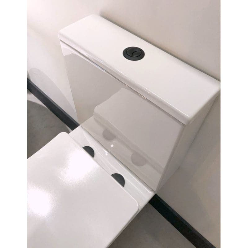 White modern close-coupled toilet with dual flush button, ideal for contemporary bathroom design, showcases high-quality bathroom fixtures for optimal hygiene and water efficiency.