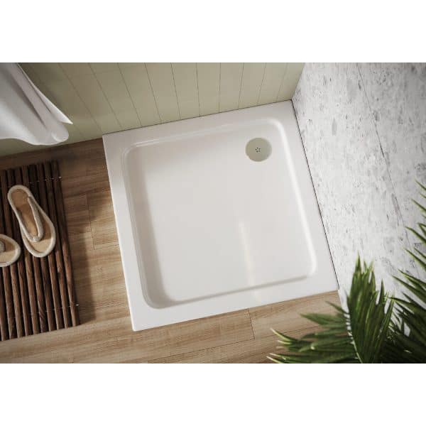 Shower tray with wooden bath mat and slippers in modern bathroom setting.