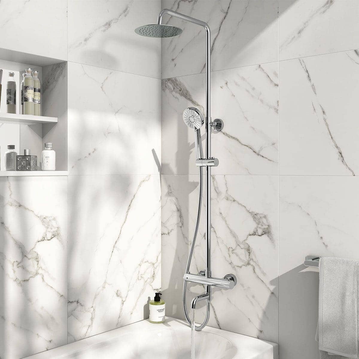 Polished chrome shower rail with overhead rain shower and handheld shower head in a modern marble-tiled bathroom.