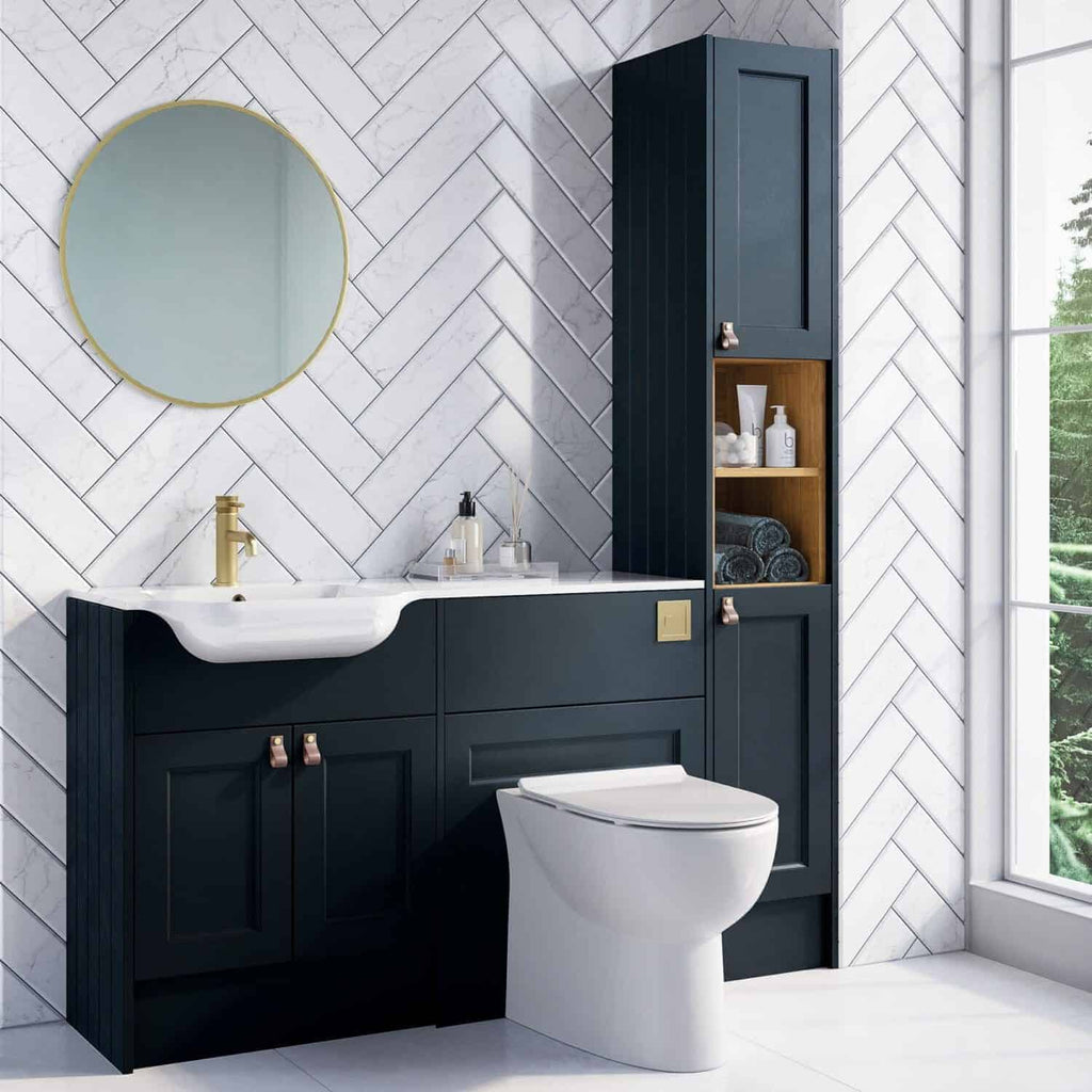 Contemporary navy bathroom vanity with white sink and gold fixtures, tall storage cabinet, oak shelving, white marble wall tiles, and large window with views of greenery.