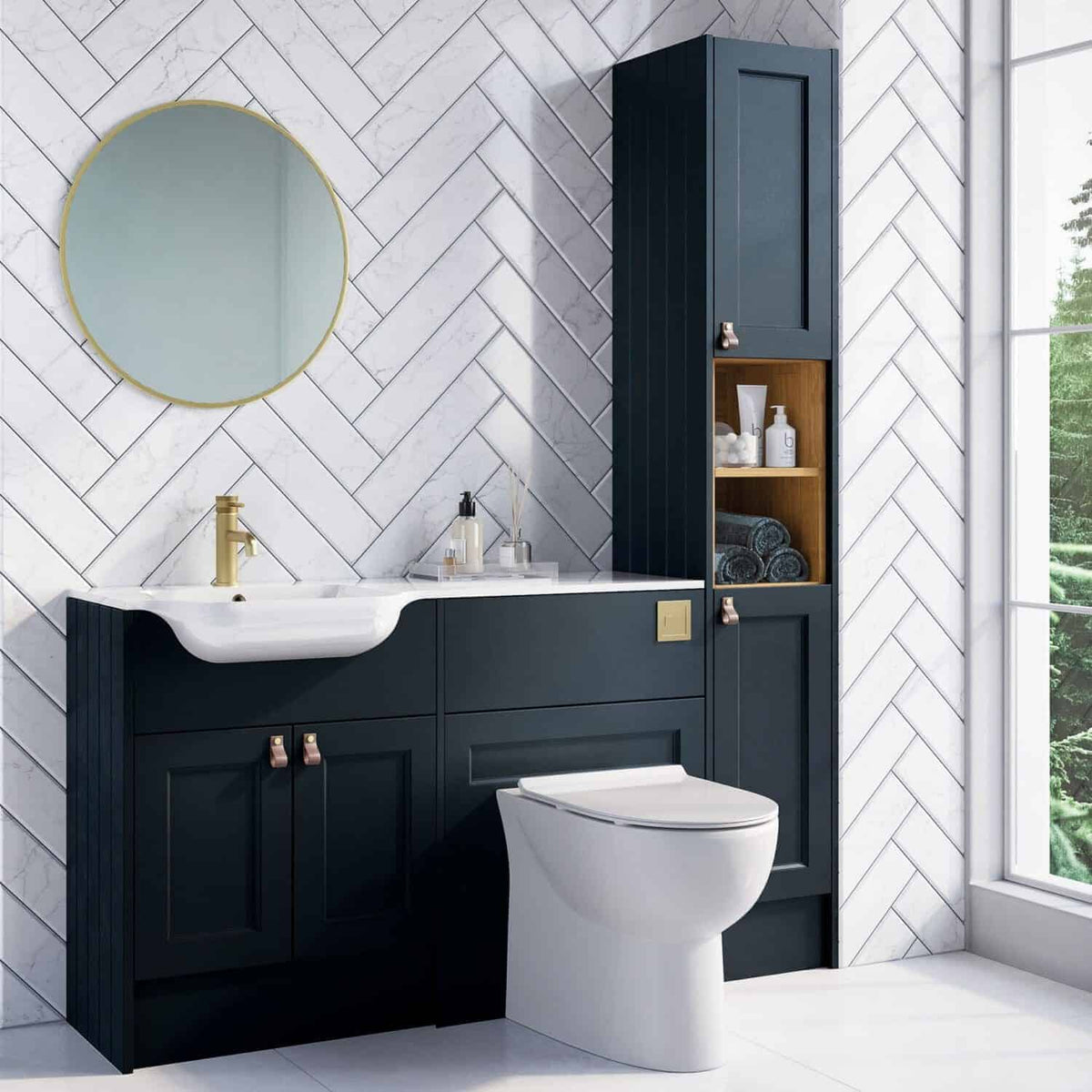 Contemporary navy bathroom vanity with white sink and gold fixtures, tall storage cabinet, oak shelving, white marble wall tiles, and large window with views of greenery.