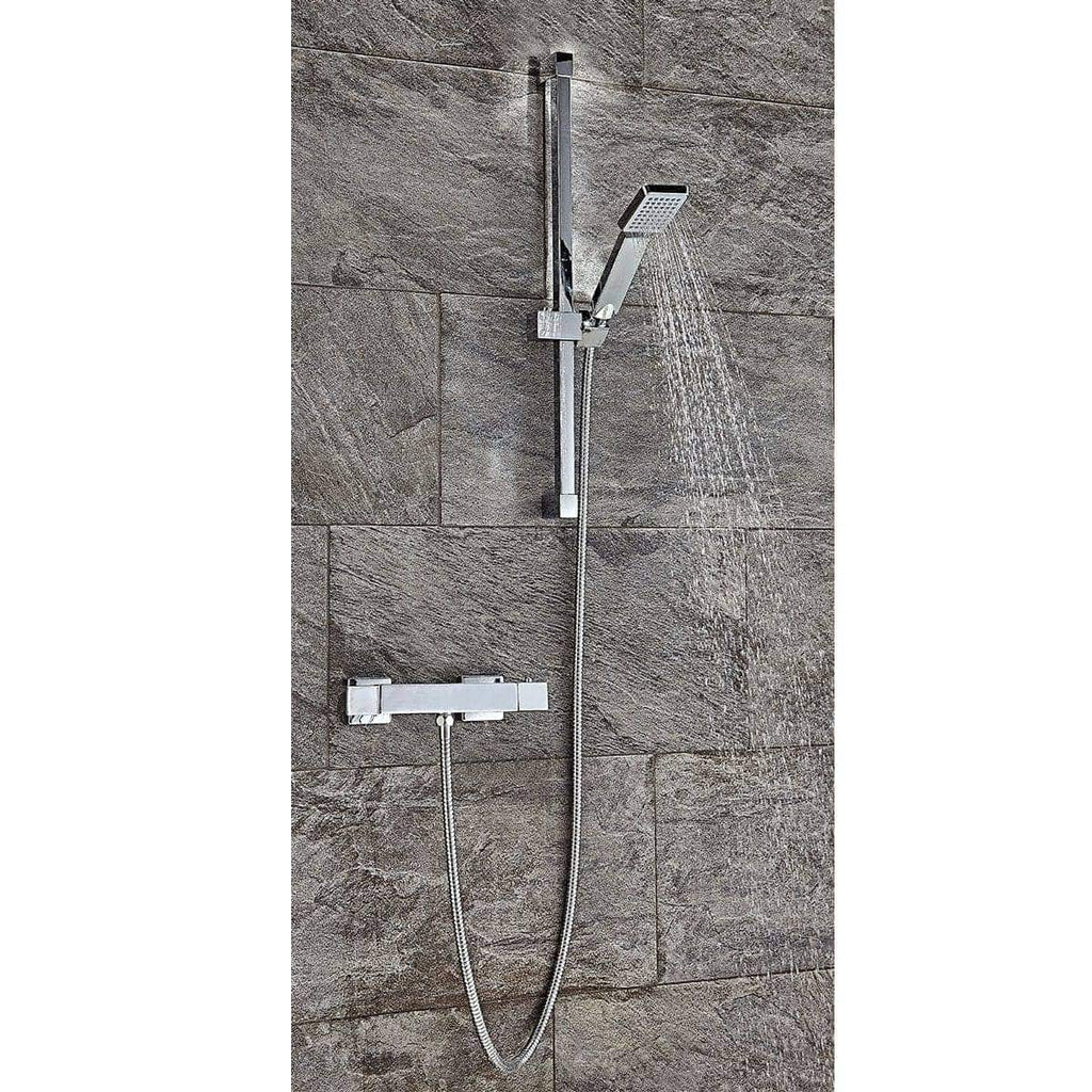 Contemporary chrome bathroom shower with handheld and overhead options, mounted on textured stone wall, ideal for modern Bubly Bathrooms designs.