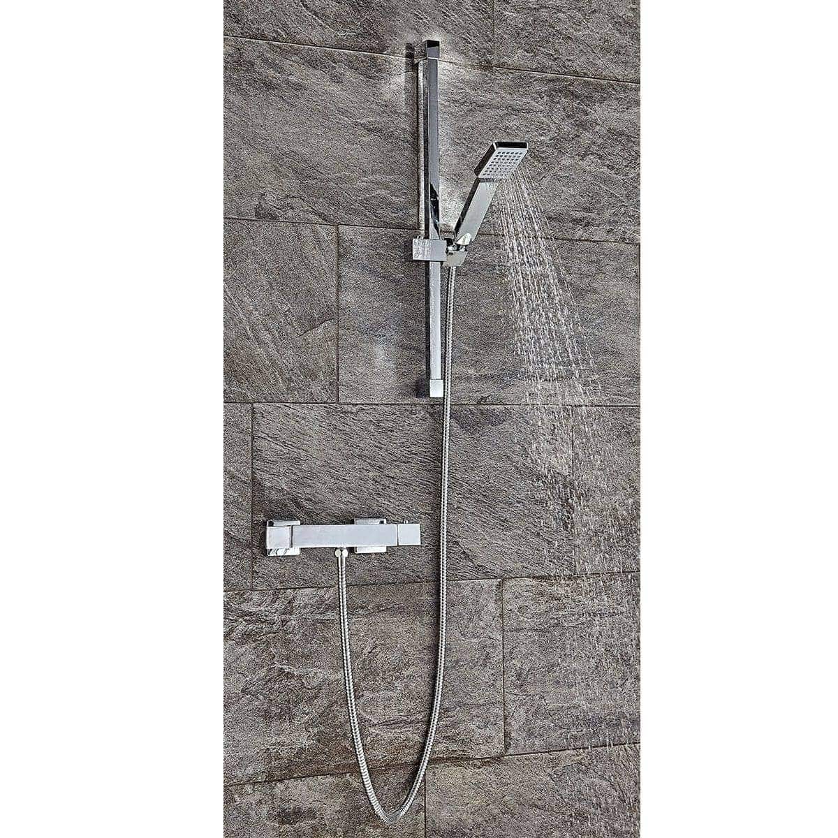 Contemporary chrome bathroom shower with handheld and overhead options, mounted on textured stone wall, ideal for modern Bubly Bathrooms designs.