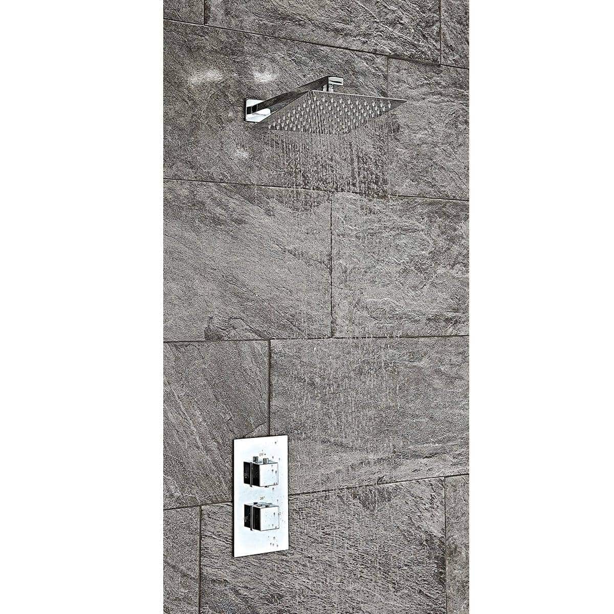 Sleek modern showerhead with handheld option on textured stone wall, showcasing contemporary bathroom design by Bubly Bathrooms.