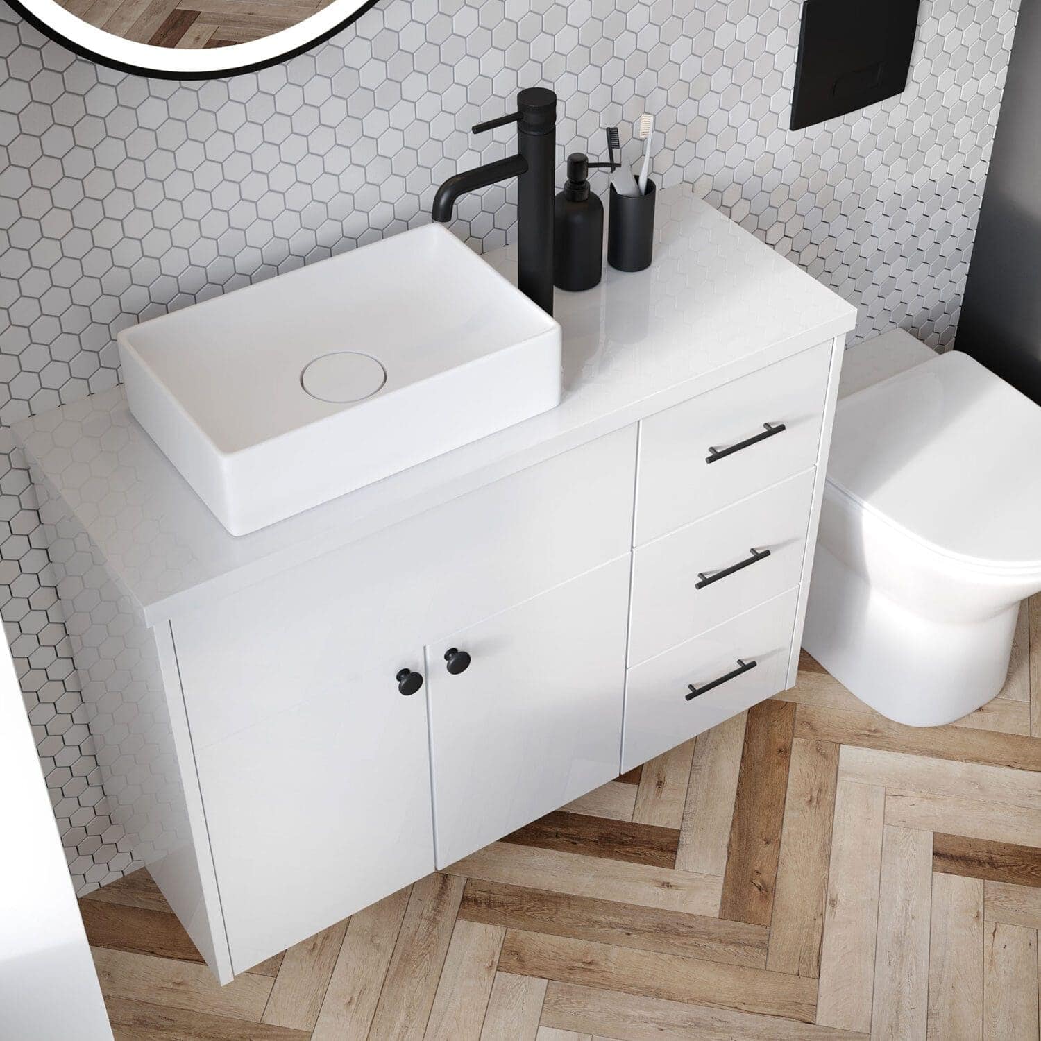Modern white bathroom vanity with a vessel sink and black fixtures, set against a hexagon tiled wall, featuring sleek drawers and cabinet storage for stylish organisation.