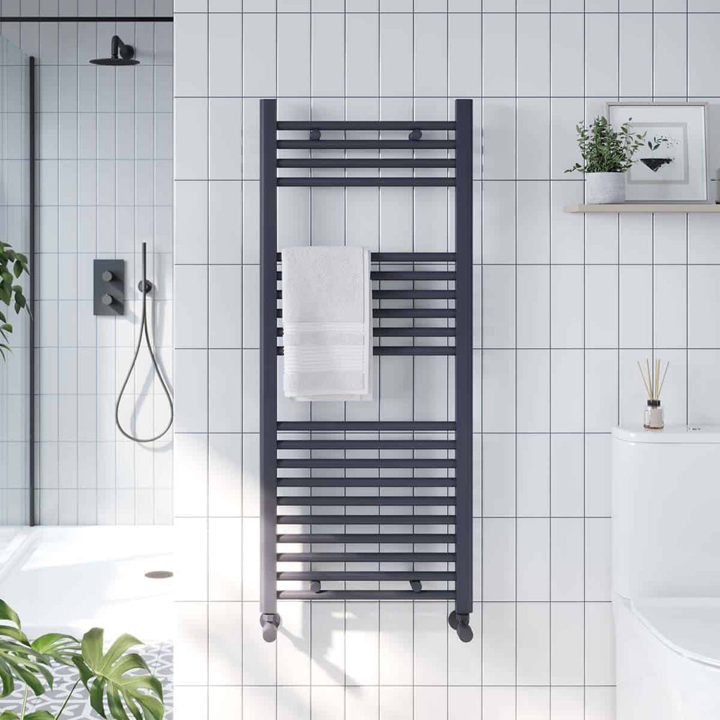 Contemporary black towel radiator in a modern white tiled bathroom.