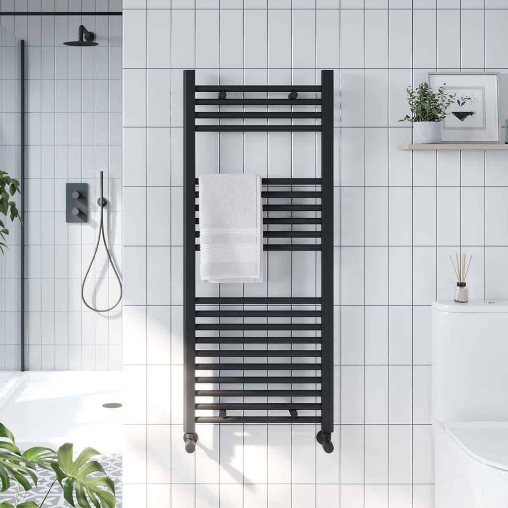 Minimalist black towel radiator in a modern bathroom with white tiled walls and contemporary decor. Perfect addition to stylish bathroom heating and towel drying solutions.
