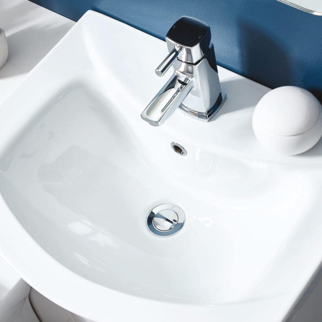 Modern white bathroom sink with chrome faucet and soap dispenser, stylish bathroom fixtures for contemporary bathroom design.
