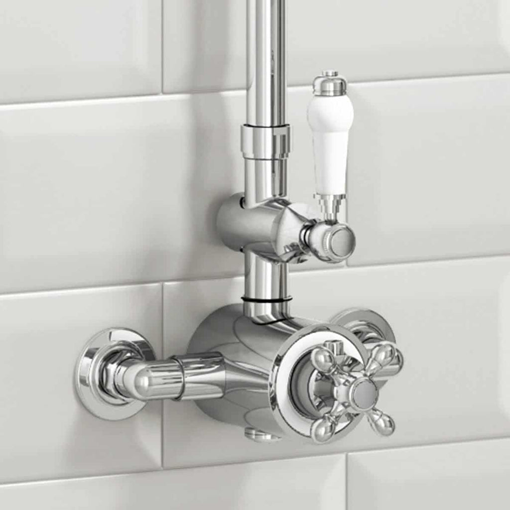 Shiny chrome bathroom tap and shut-off valves mounted on a white tiled wall, demonstrating modern bathroom plumbing fixtures.
