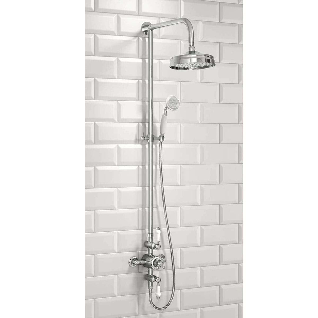 Chrome shower head and handheld shower attachment with adjustable pipe, modern bathroom design, white subway tile background, Bubly BathroomsElegant chrome shower system ideal for contemporary bathrooms, featuring a rainfall shower head and handheld spray for a versatile shower experience. Perfect for upgrading your bathroom with stylish fixtures from Bubly Bathrooms.