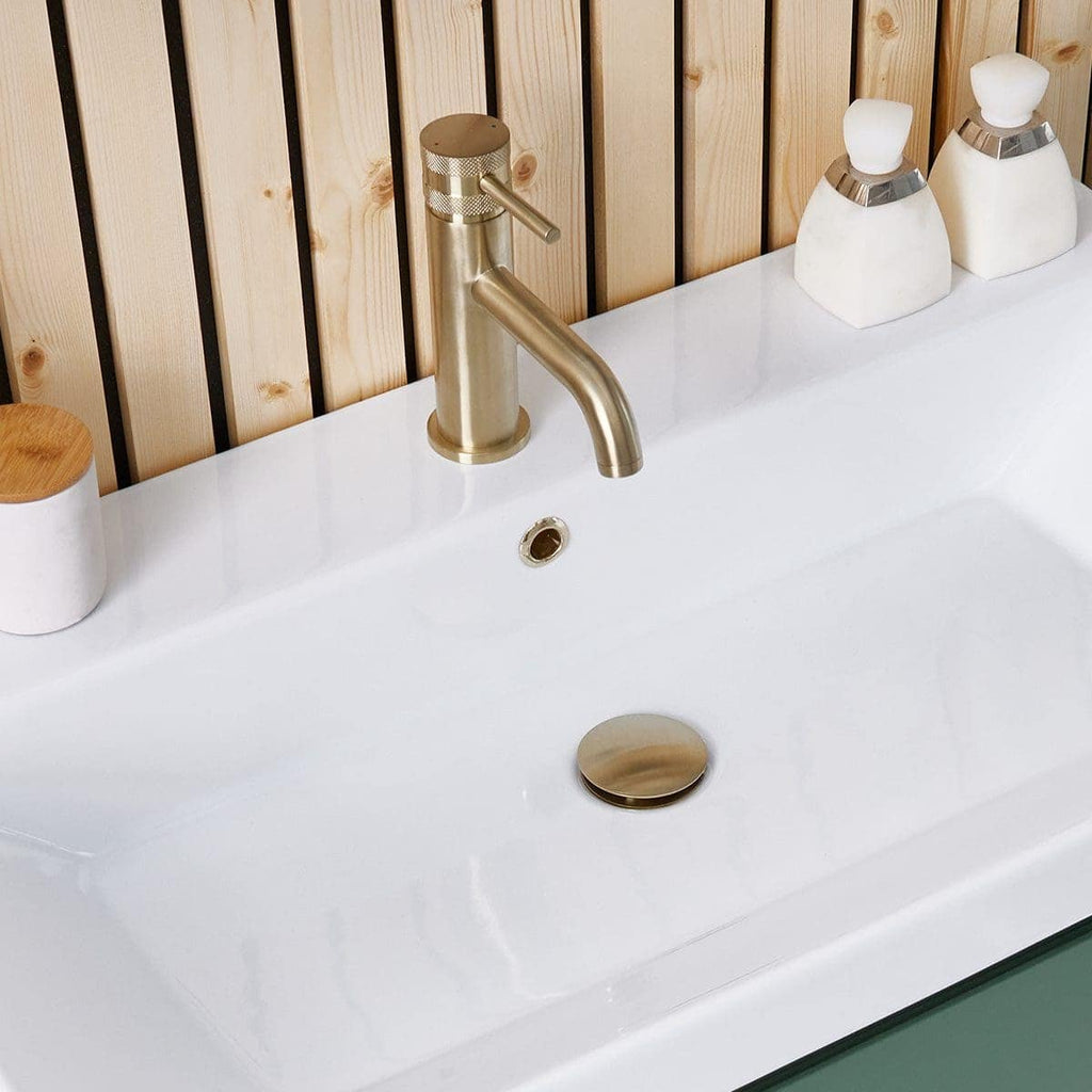 Sleek modern bathroom sink with brushed gold tap, minimalist soap dispensers, and wooden wall paneling, perfect for contemporary bathroom design.