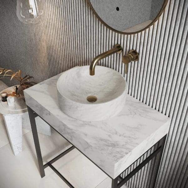 Sleek marble bathroom vessel sink with brass faucet and modern design, perfect for contemporary bathrooms. Features elegant wall paneling and stylish accessories in a luxurious setting.
