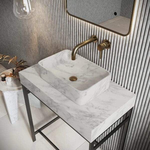Marble bathroom vanity with brass fixtures, modern design, and a sleek mirror, showcasing high-quality Bubly Bathrooms fixtures for contemporary bathroom decor.