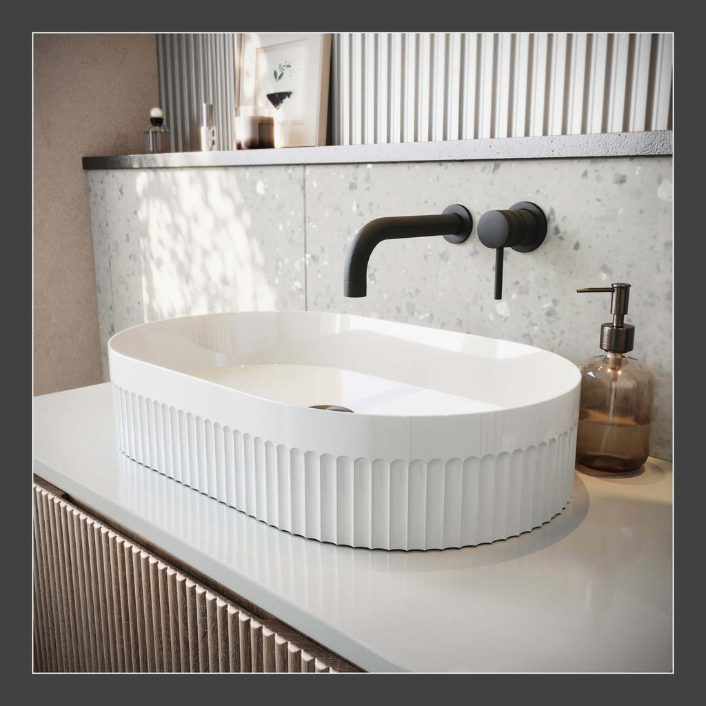 Sleek modern oval bathroom sink with ribbed exterior, black wall-mounted faucet, and minimalist decor in a contemporary bathroom setting for enhanced bathroom design.