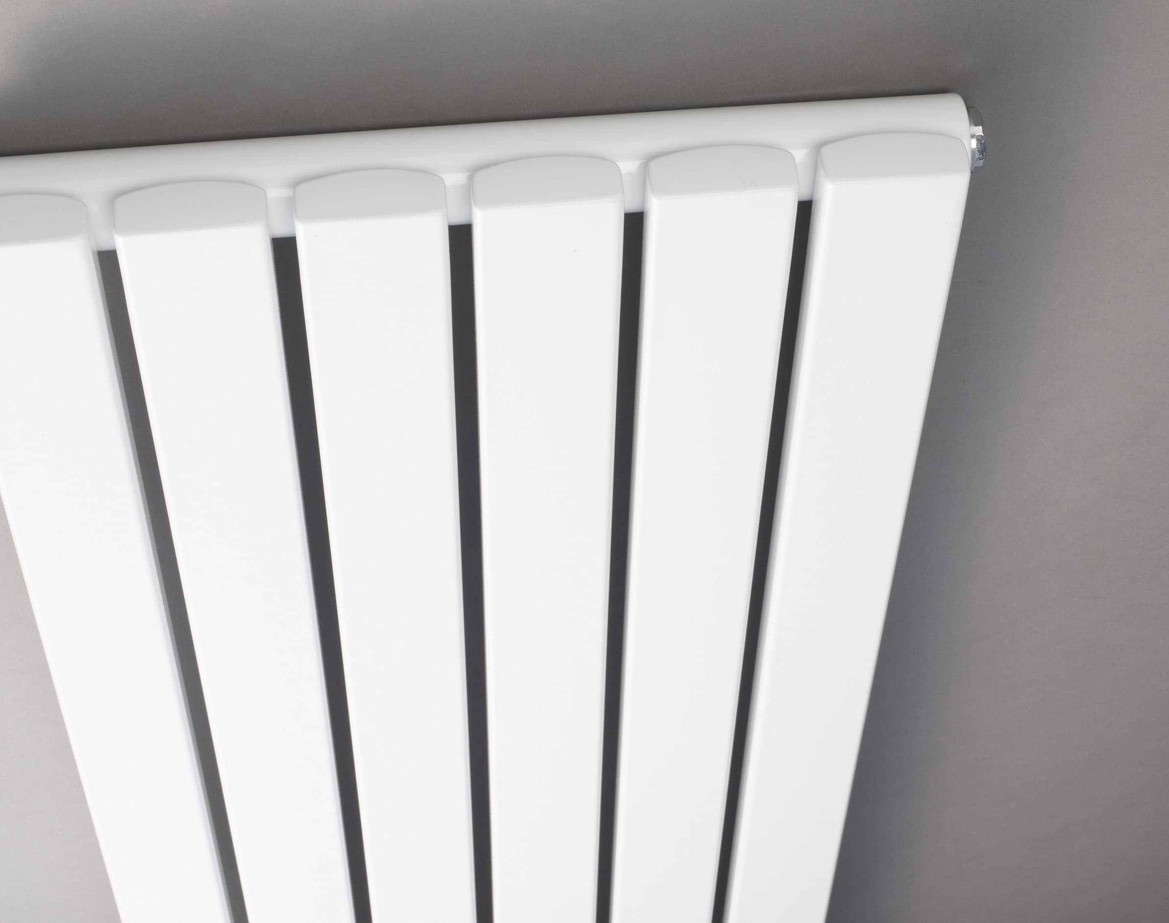 Radiator heater in a modern bathroom, white vertical panel design, focal point for bathroom heating, sleek and functional bathroom radiator, ideal for bathroom comfort and style.