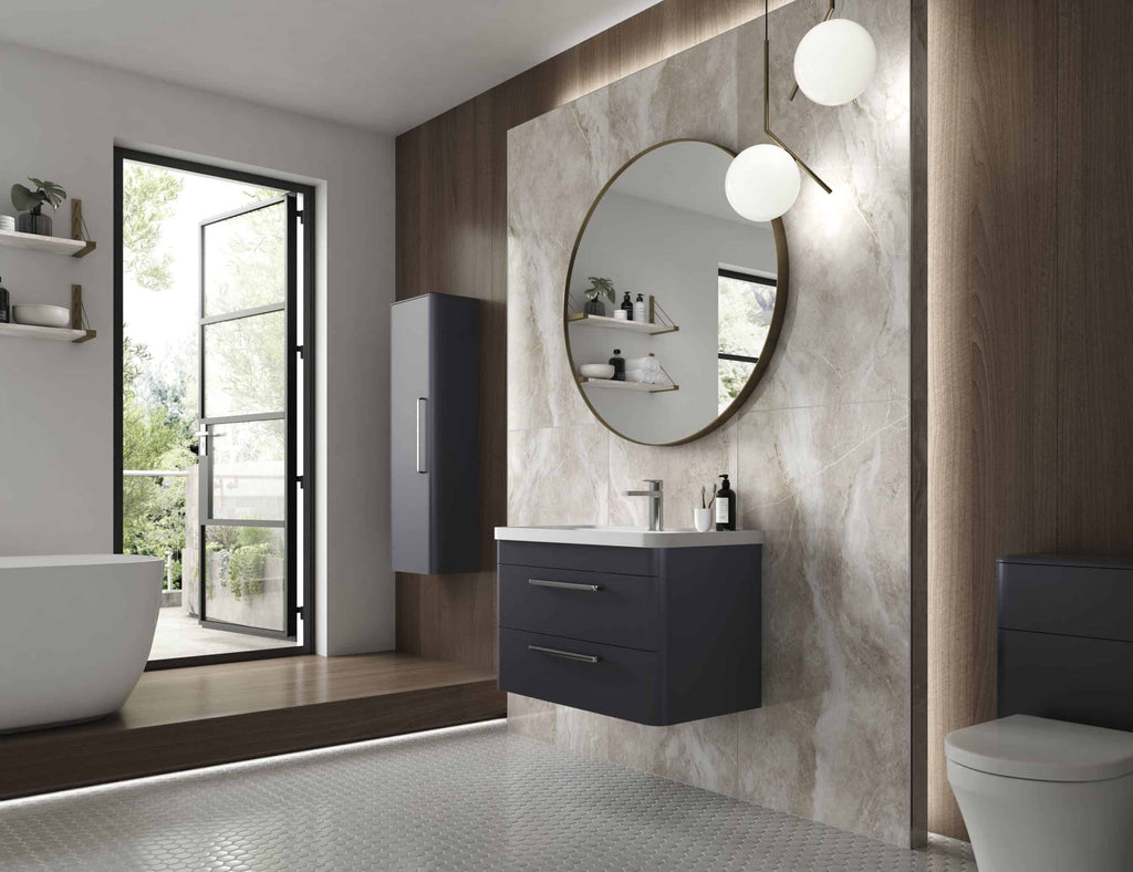 Sleek modern bathroom with a floating vanity unit, round mirror, and natural stone tiles, featuring minimalist design and ample natural light. Perfect for contemporary Bubly Bathrooms housing solutions.
