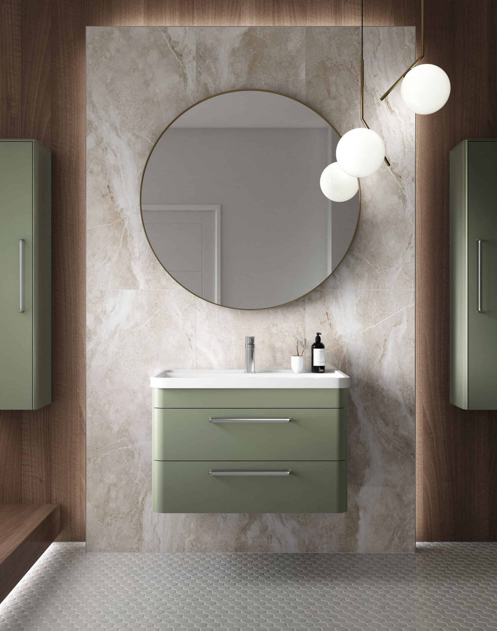 Sleek green bathroom vanity with integrated sink and modern chrome handles, complemented by large circular mirror and stylish lighting fixtures, creating a contemporary bathroom design.
