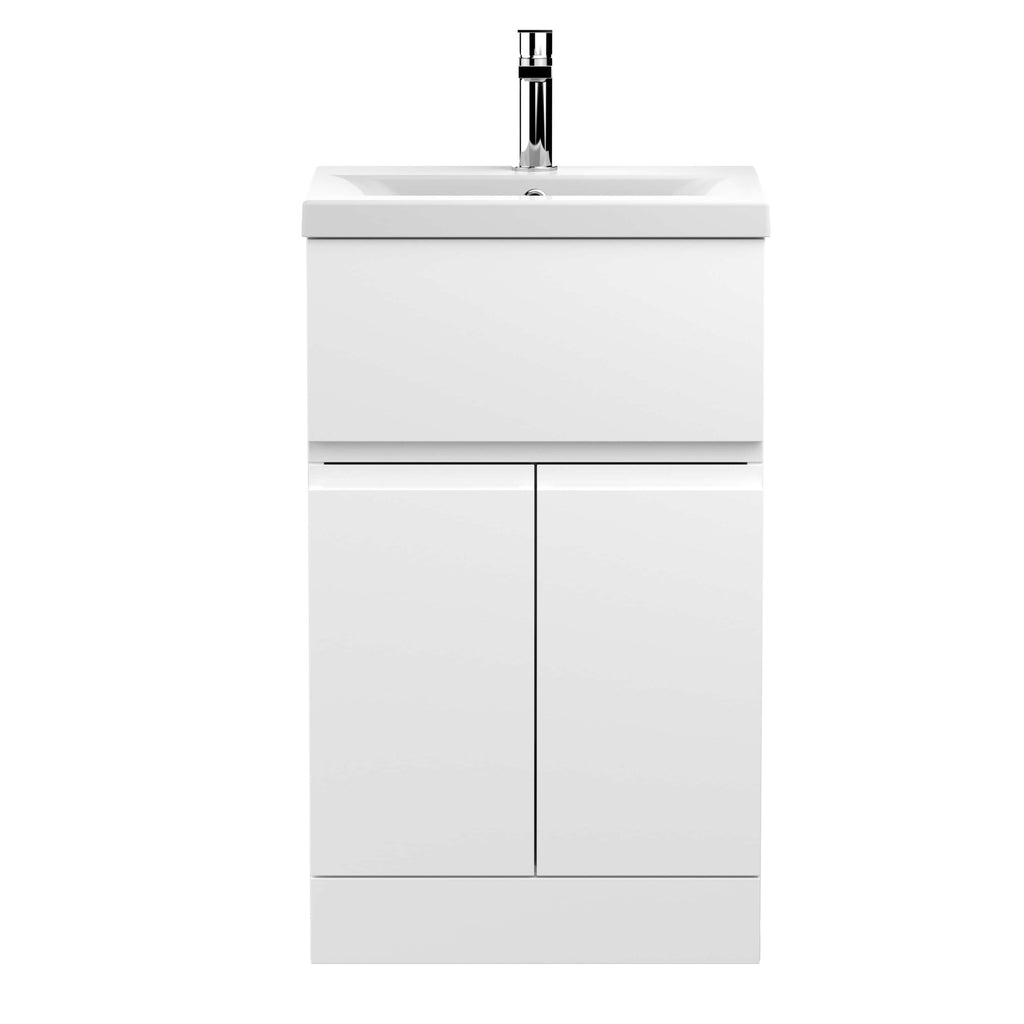 Sleek white bathroom vanity unit with integrated sink and modern chrome tap for contemporary bathroom design.