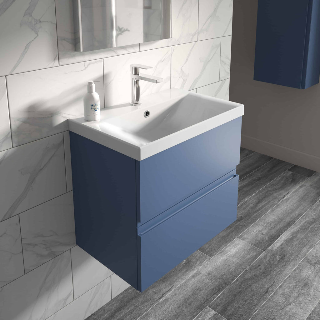 Blue bathroom vanity with integrated sink and chrome faucet in modern bathroom decor.