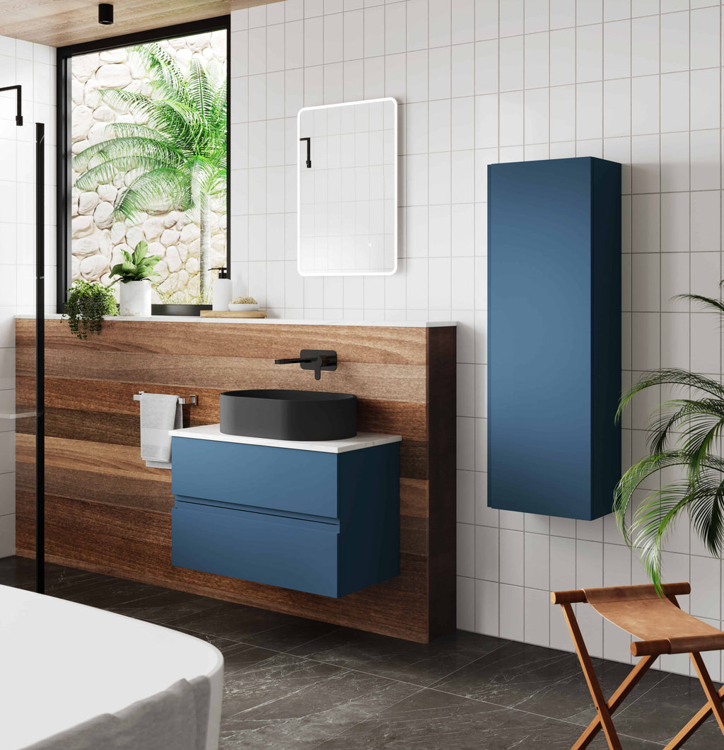 Sleek modern bathroom featuring blue floating vanity with black vessel sink, wall-mounted mirror with integrated lighting, tall blue storage cabinet, and natural wood accents, creating a stylish and functional space.