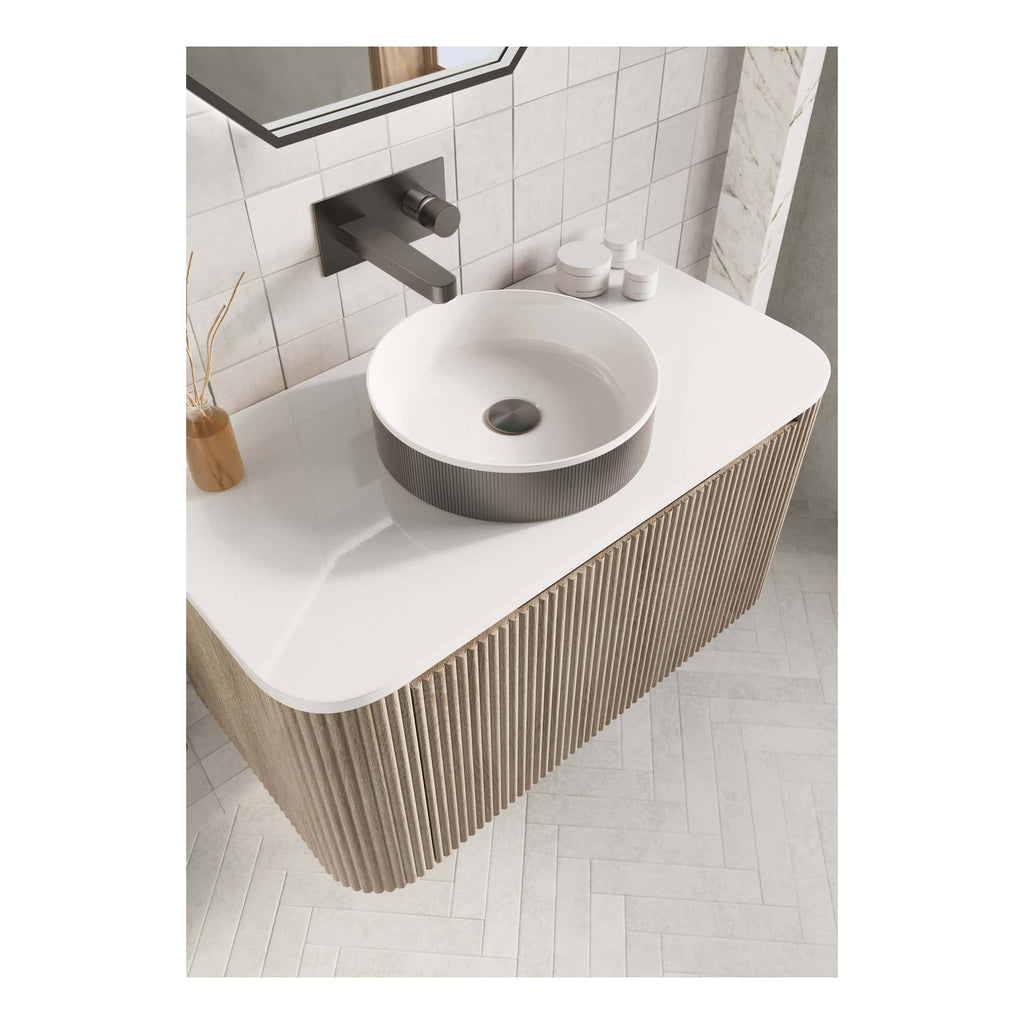 Sleek modern bathroom vanity with a round vessel sink, wall-mounted faucet, and minimalist design in neutral tones, perfect for contemporary bathroom interiors.
