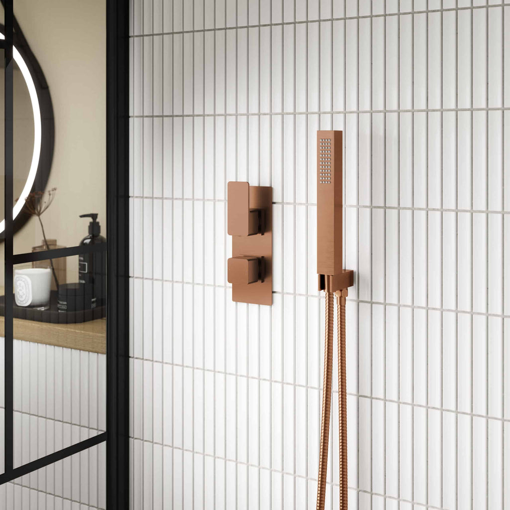 Elegant copper bathroom shower fixture with modern handheld shower and wall-mounted controls, designed for stylish and functional wet room or shower area.
