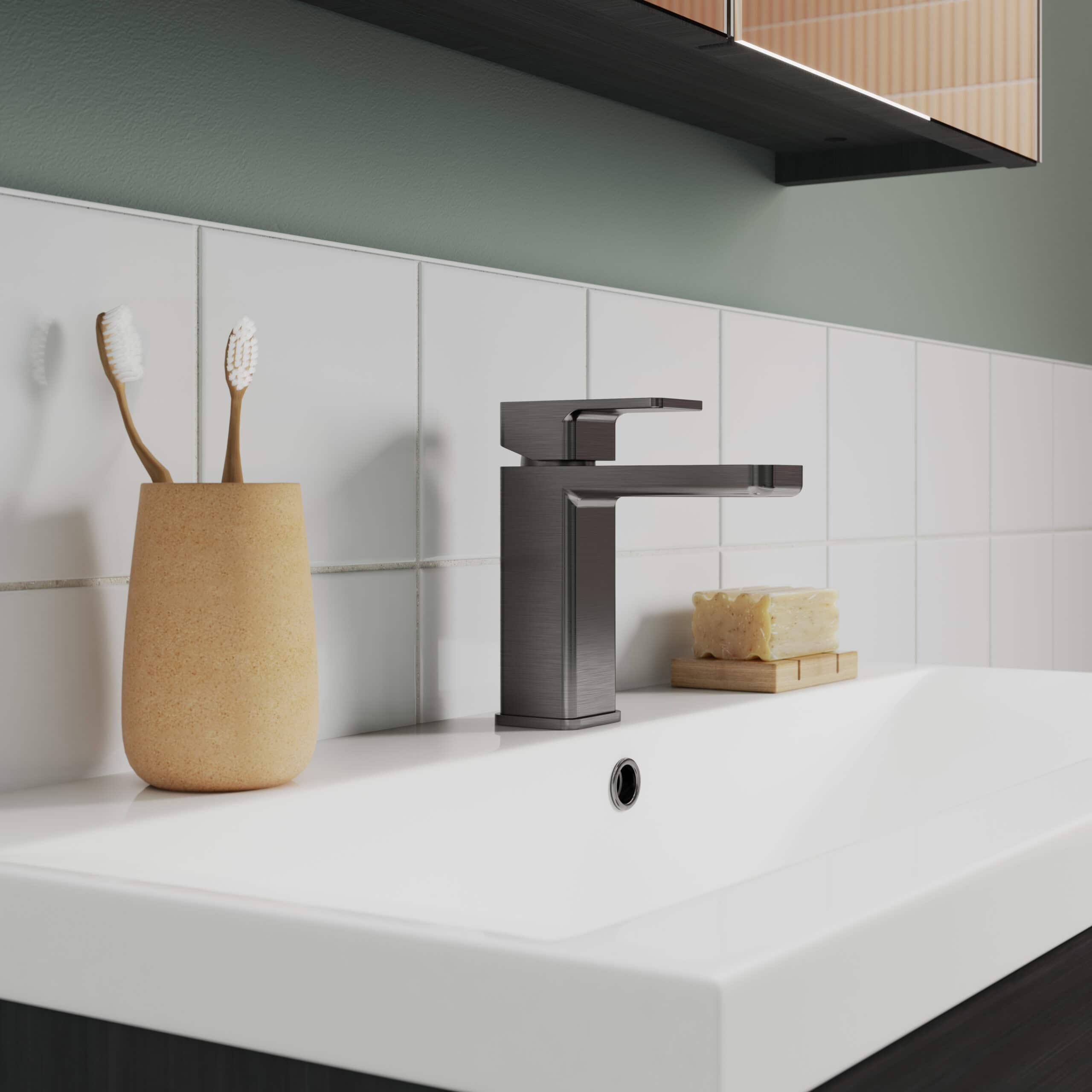 Sleek modern bathroom sink with chrome faucet, beige toothbrush holder, natural soap bar on wooden tray, clean white tiles, minimalist design, perfect for contemporary bathroom decor.