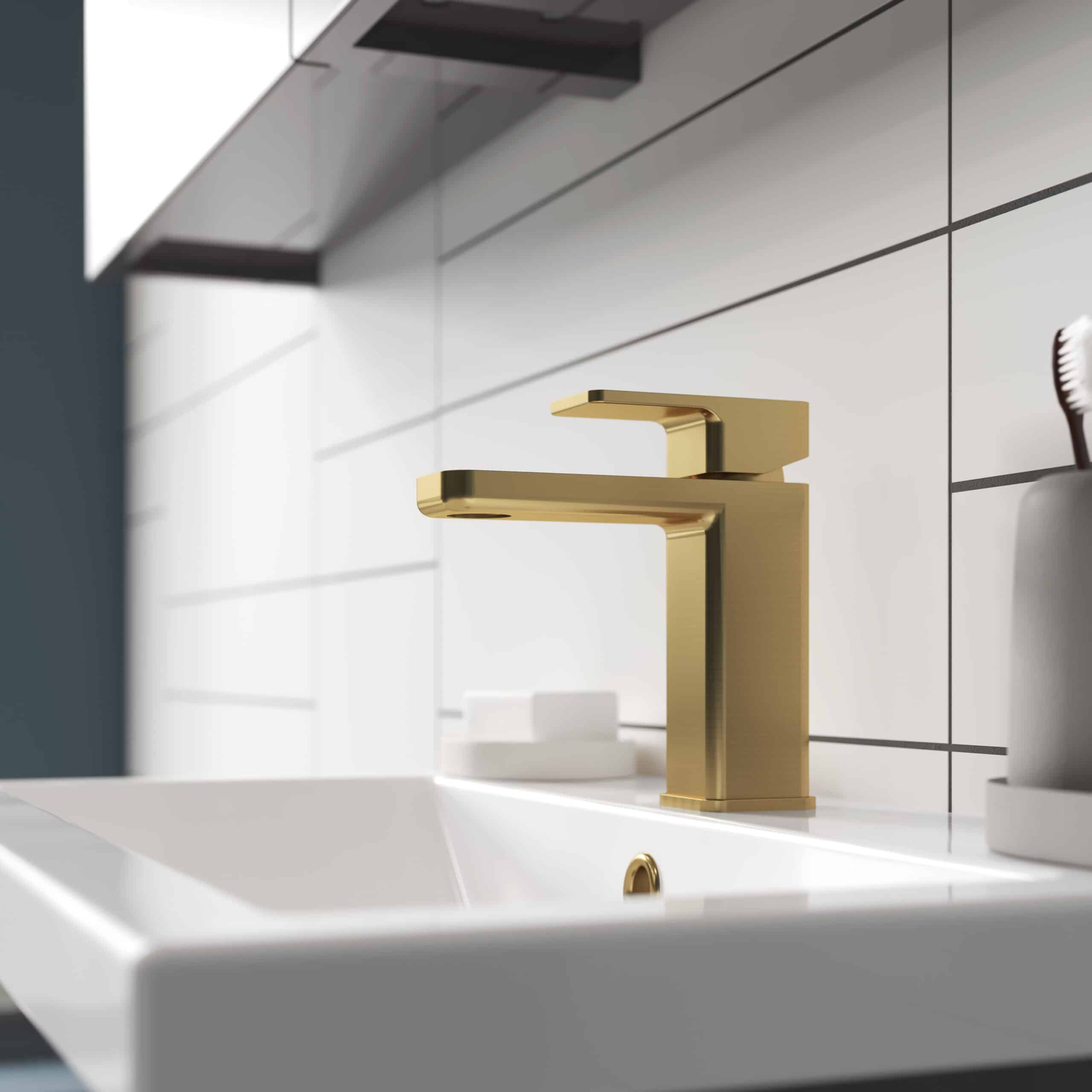 Luxury gold bathroom tap on white sink with tiled wall, modern bathroom fixture, elegant design for contemporary bathroom renovation, focus on high-end bathroom fittings, Bubly Bathrooms UK.