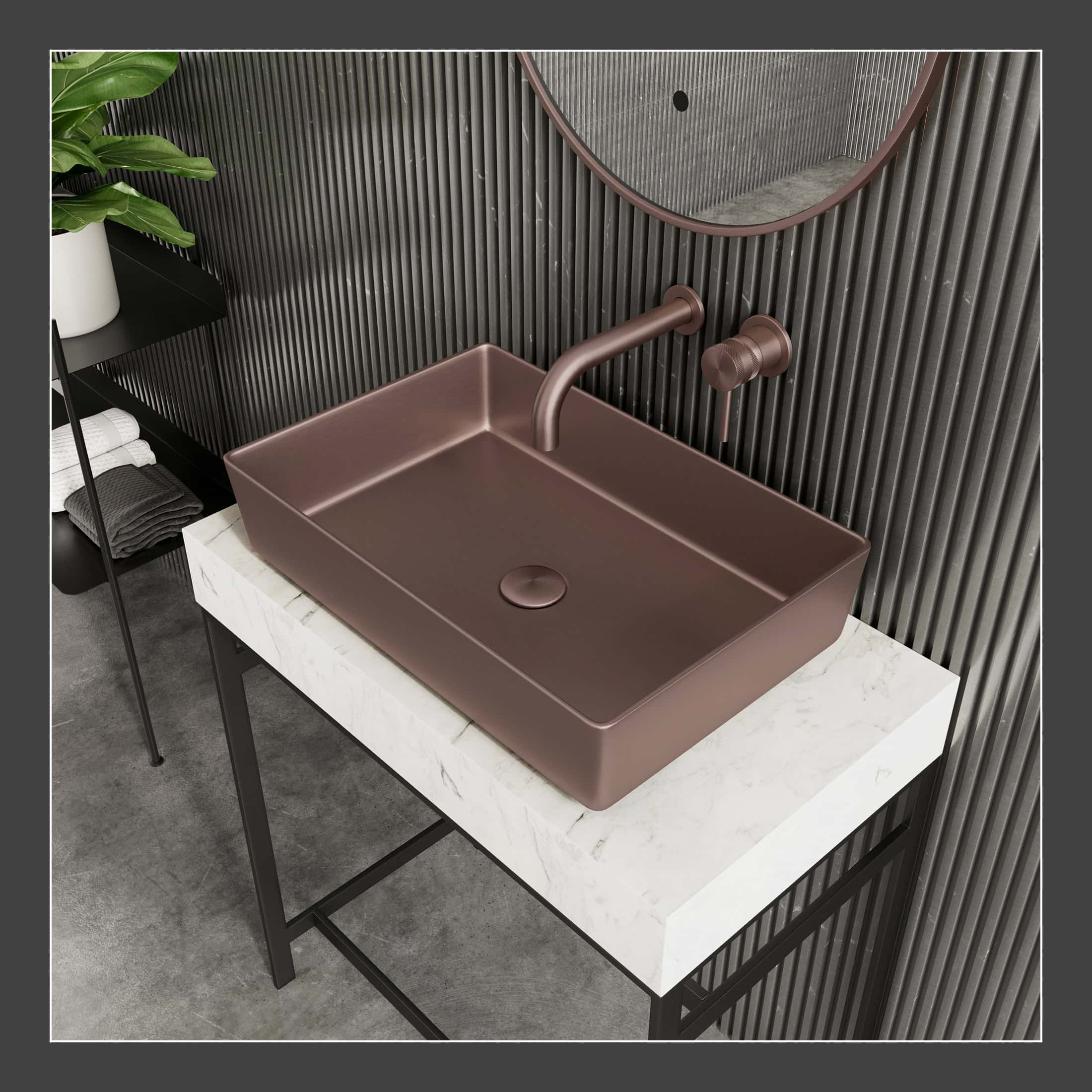 Brushed bronze bathroom sink with modern wall-mounted faucet and round mirror in sleek contemporary bathroom setup.