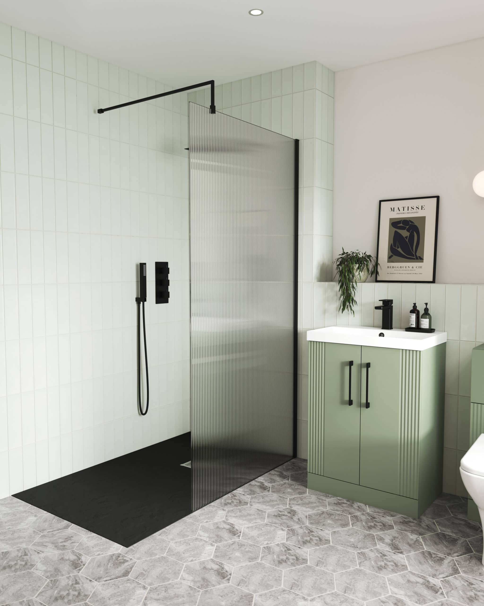 Sleek walk-in shower with black fixtures and a textured glass screen in a modern bathroom. Features a minimalist style with green cabinetry, monochrome decor, and contemporary touches for stylish bathroom design.