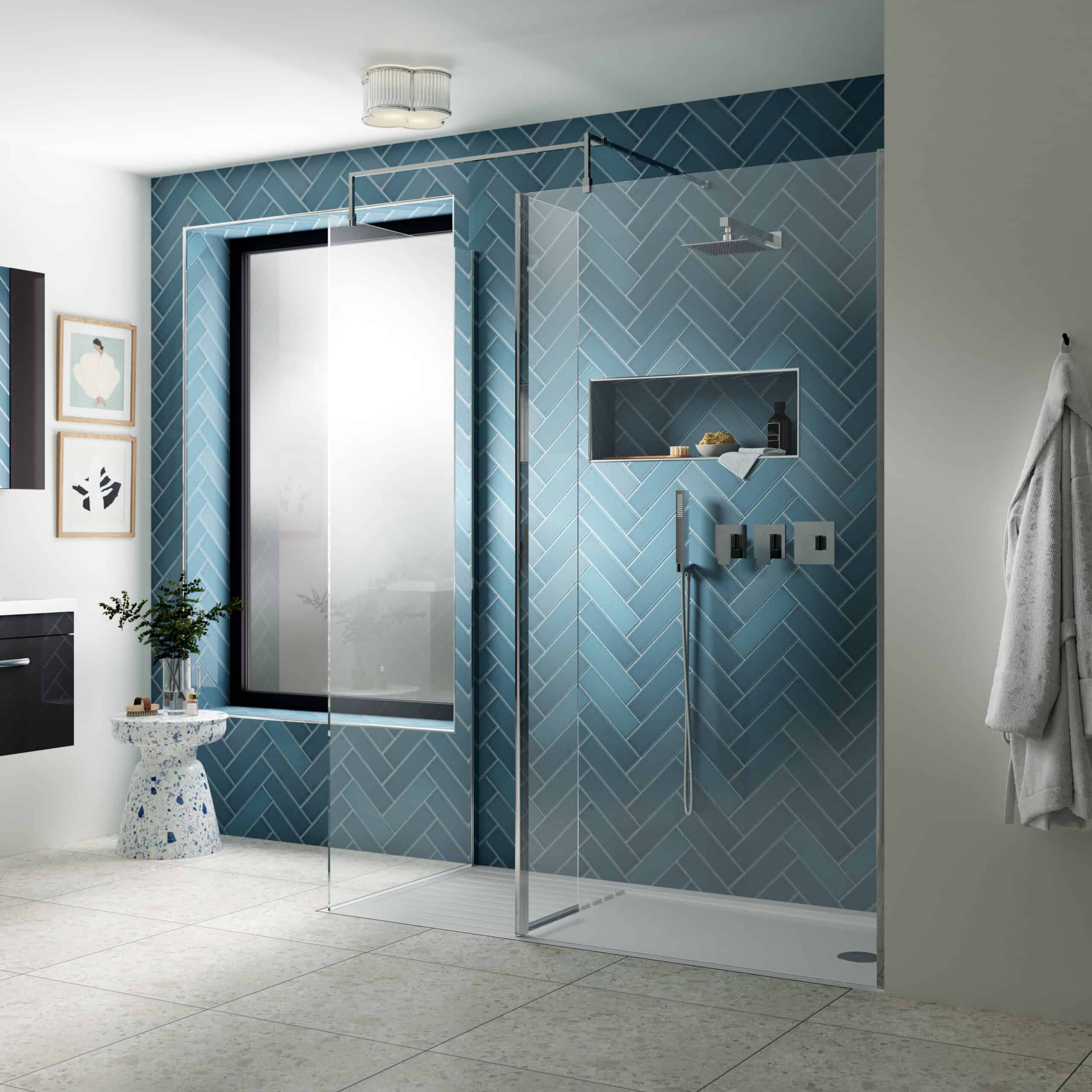Modern walk-in shower with blue herringbone tiled accent wall, sleek glass screen, and contemporary fixtures in a stylish bathroom setting.