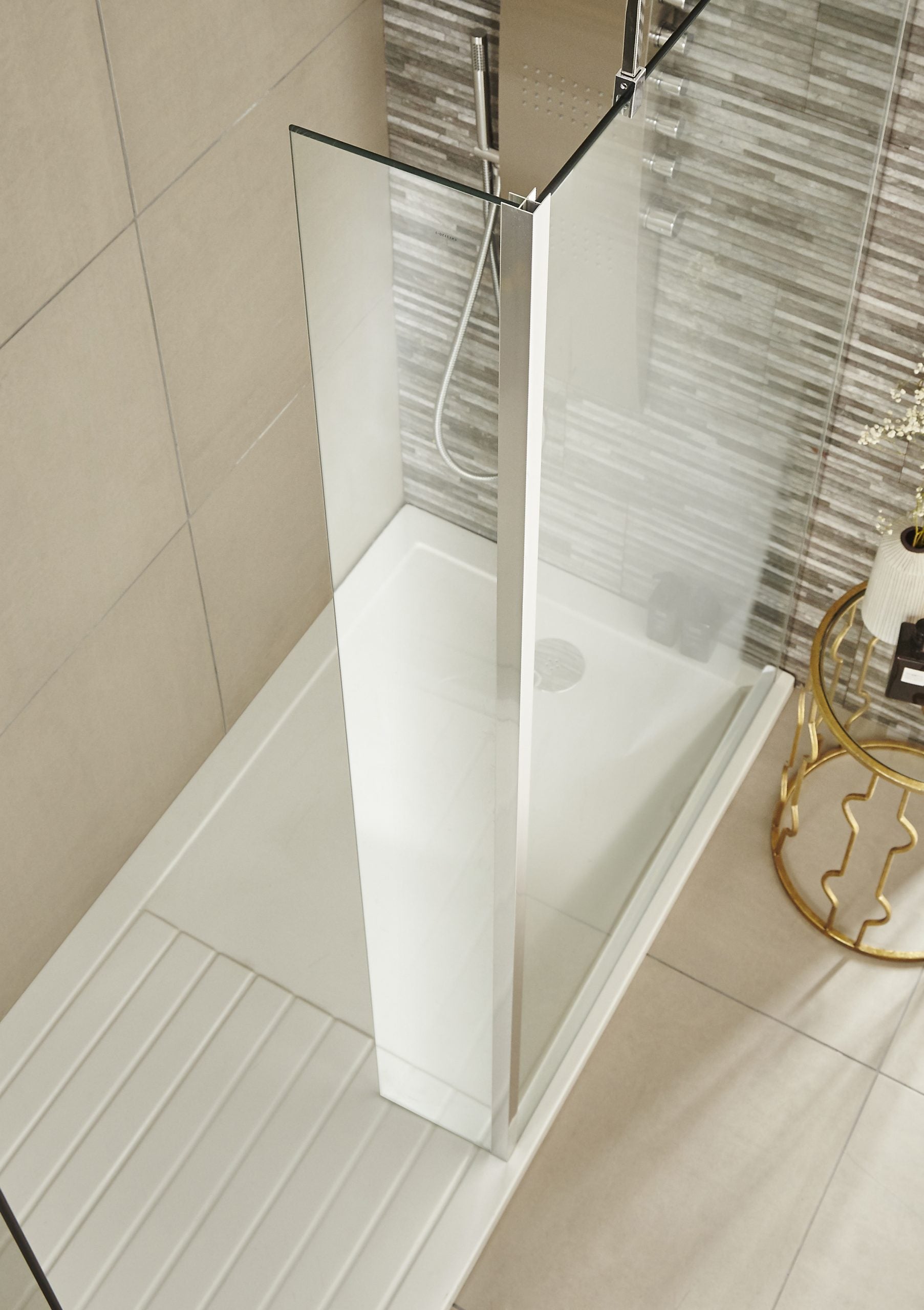 Bright modern walk-in shower enclosure with clear glass panels, chrome fittings, and sleek design, perfect for contemporary bathroom renovation.