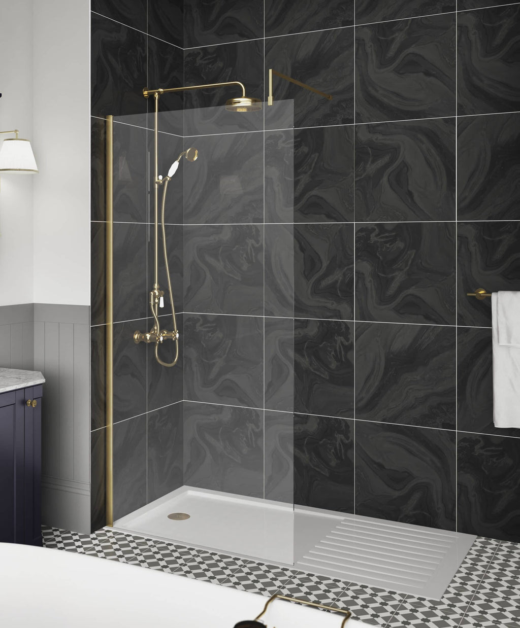 Shower area with gold fixtures, black marble tiles, glass screen, and black-and-white patterned floor in modern bathroom design.