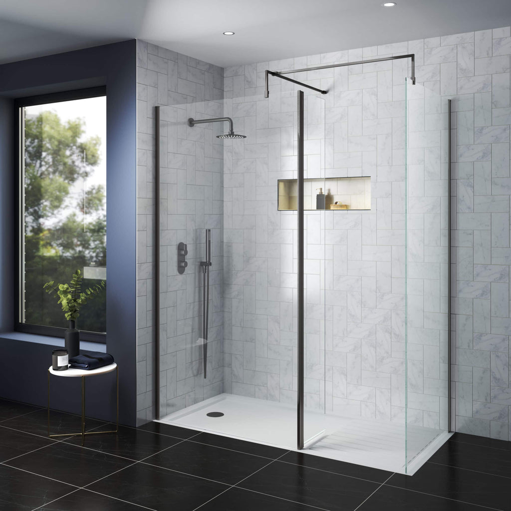 Modern walk-in glass shower enclosure with sleek stainless steel fixtures, white marble tiles, and a wall niche for toiletries in a contemporary bathroom.