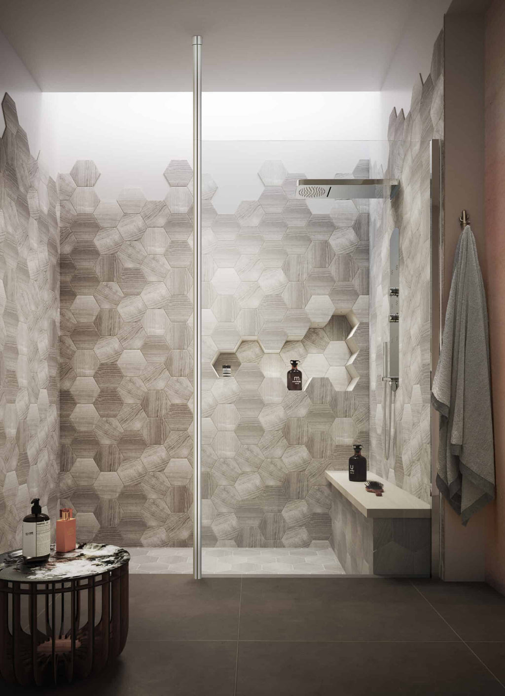 Luxurious walk-in shower with modern hexagon tile design, rainfall showerhead, and built-in niche for toiletries in a contemporary bathroom.