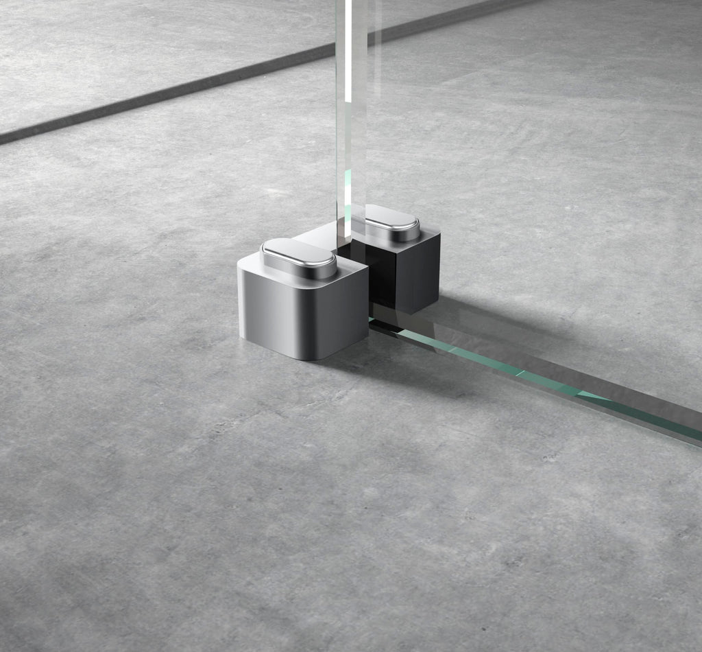 Sleek modern glass shower door with minimalist chrome hinges on a grey tiled bathroom floor.