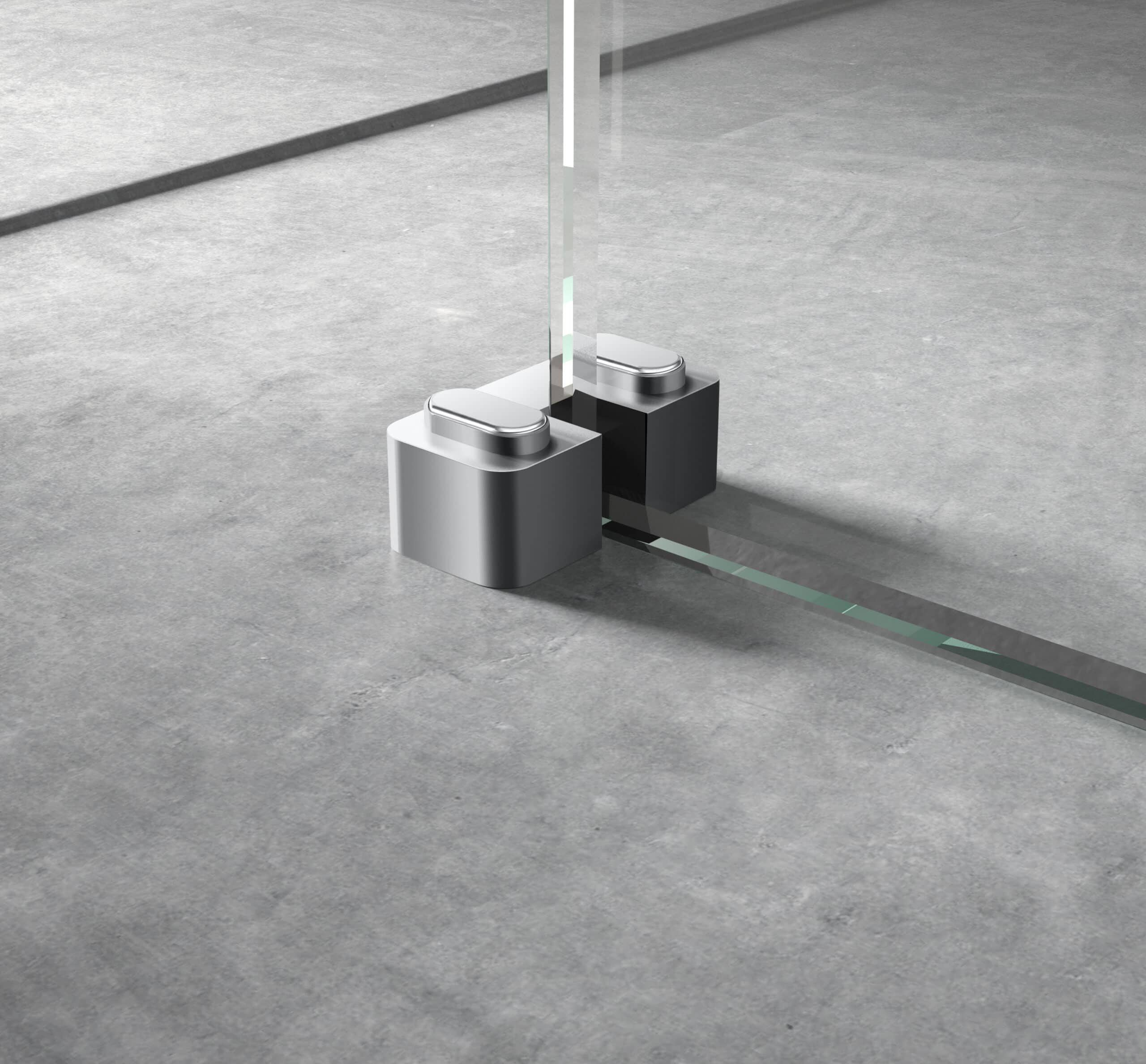Sleek modern glass shower door with minimalist chrome hinges on a grey tiled bathroom floor.