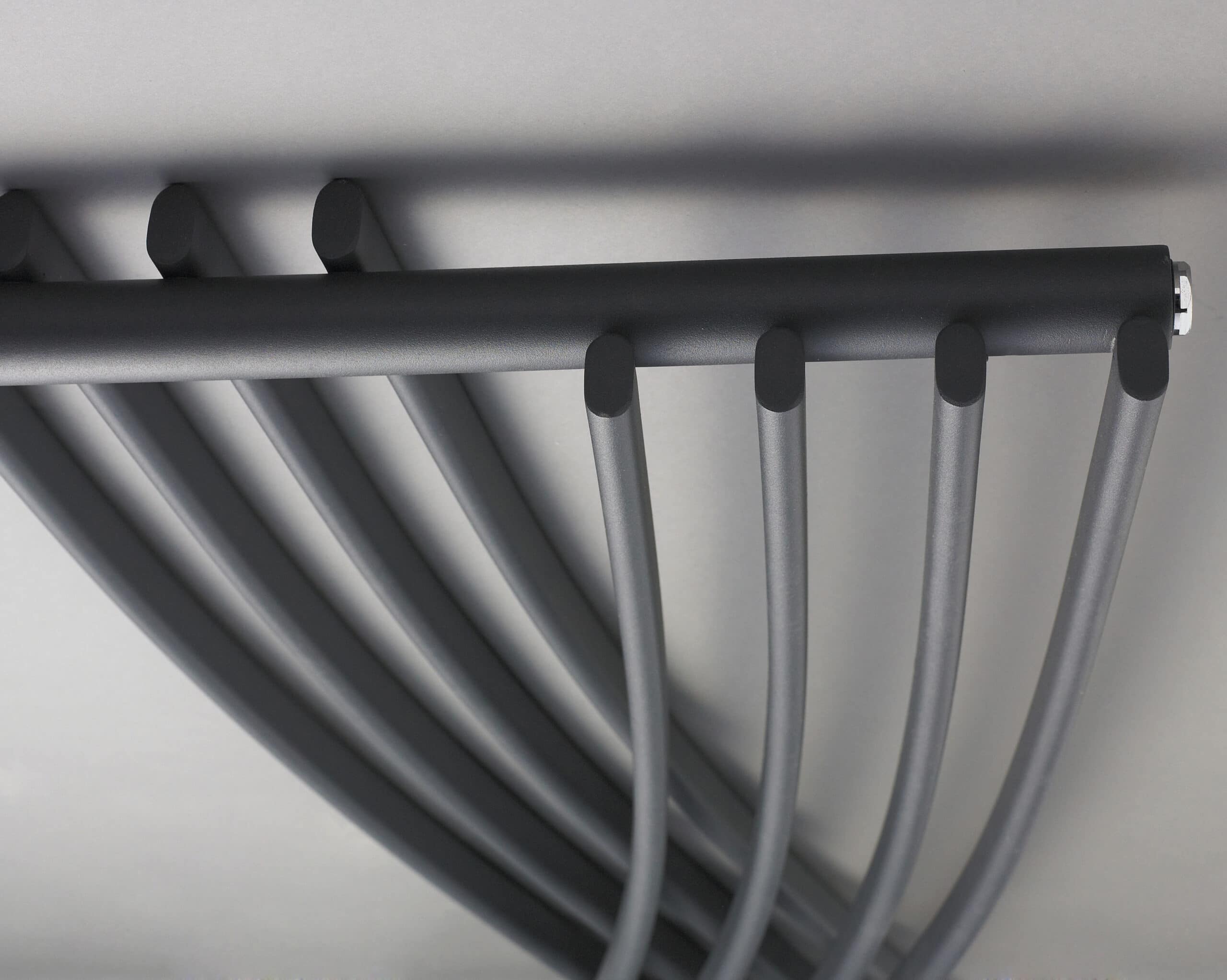Sleek black towel radiator in a modern bathroom, ideal for heating and towel drying, showcasing stylish and functional bathroom radiators for contemporary bathroom design.